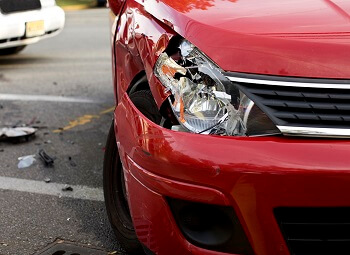 closeup of a car with a smashed headlight