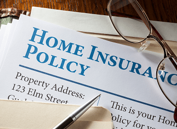 paper that reads home insurance policy in a manila folder
